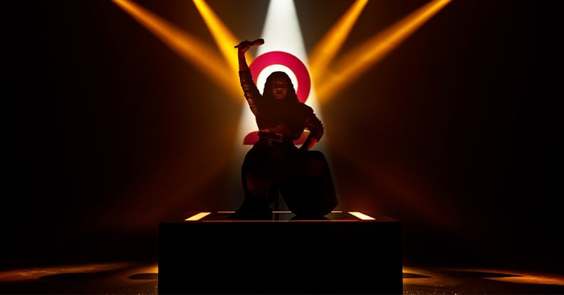 A performer with spotlights trained on her